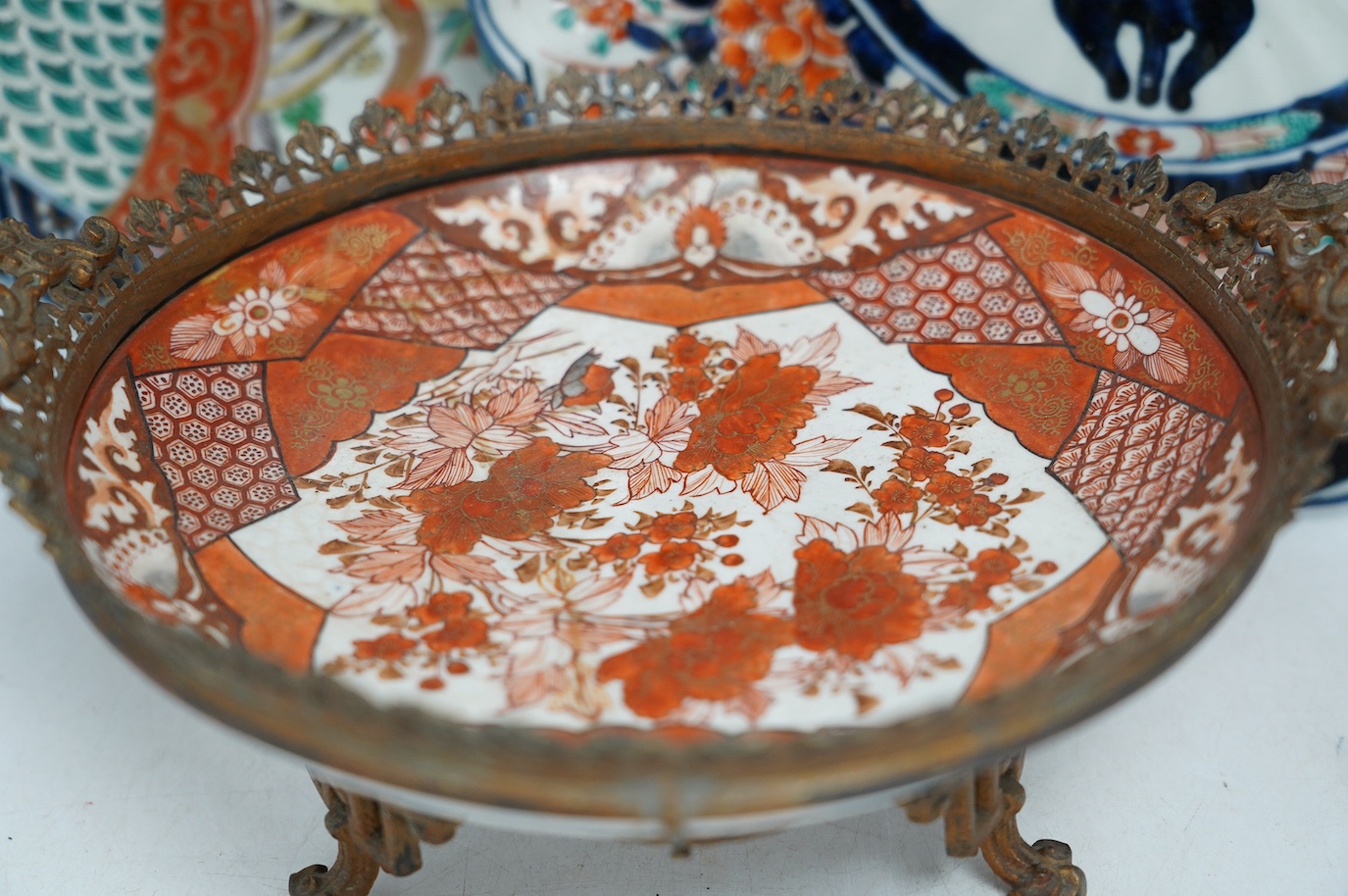 Five Japanese Imari dishes and a Kutani gilt metal mounted bowl, Meiji period, largest 35cm. Condition - poor to fair